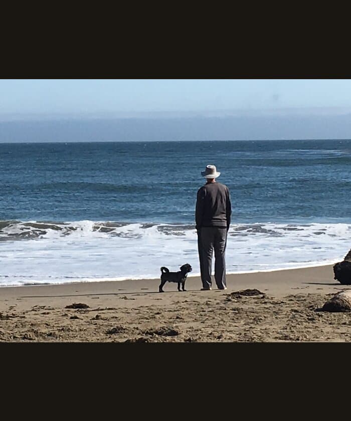 Wylie and his dog looking out at the ocean